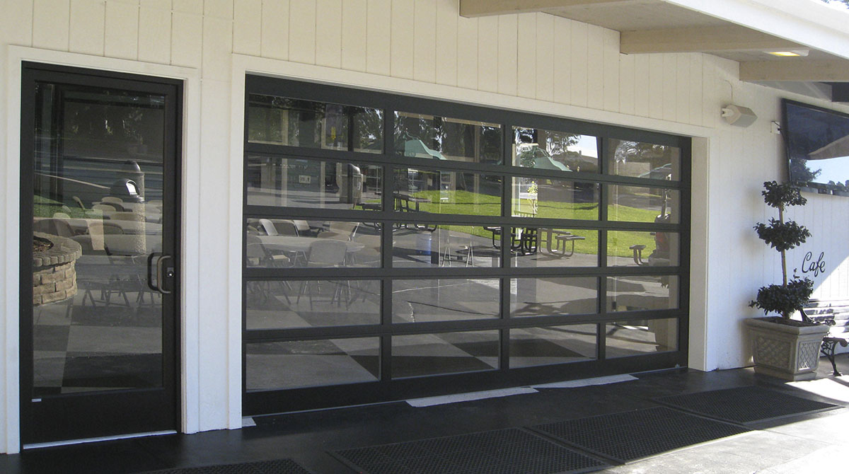 Commercial glass garage doors for modern building exterior design