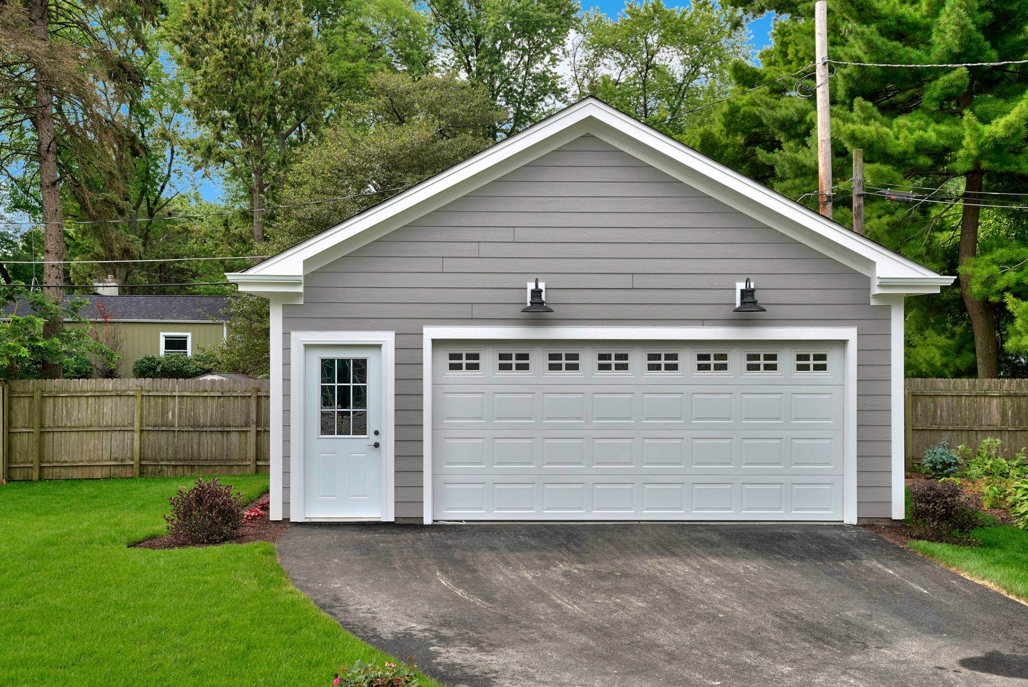 Contractor installing a man door in a garage